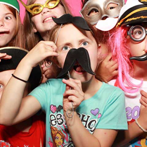 Kids in one of our Photo Booths with Photo Booth Props
