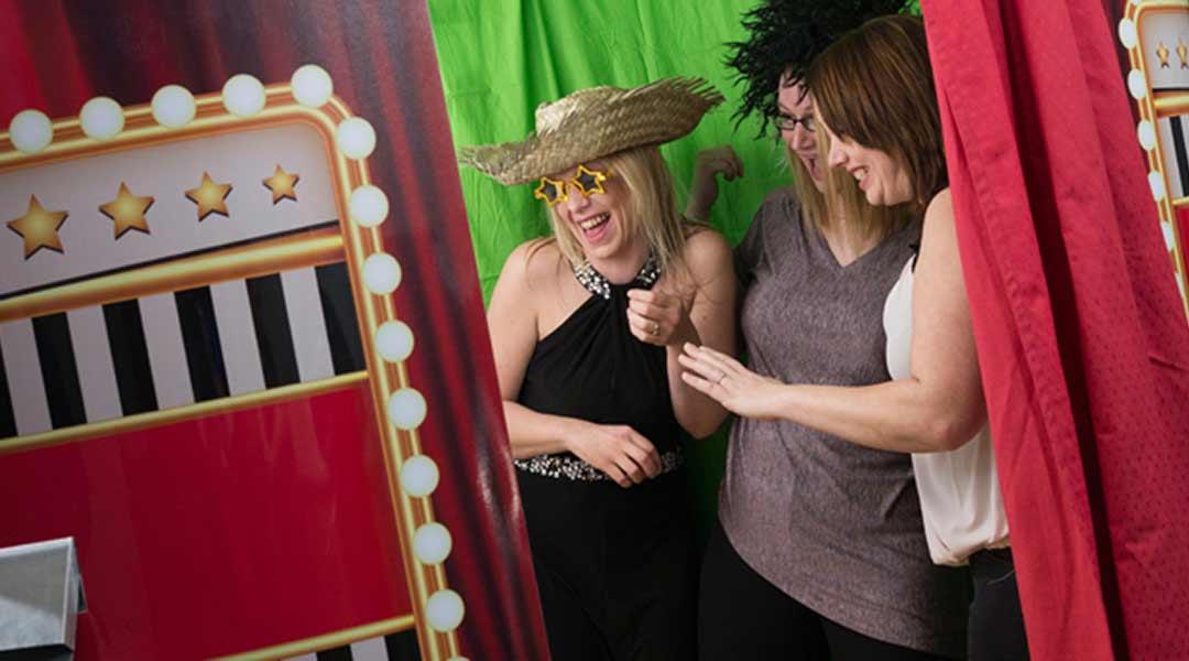 Picture demonstrates people using a Photo Booth in a Blog about which Booth to choose for their event.